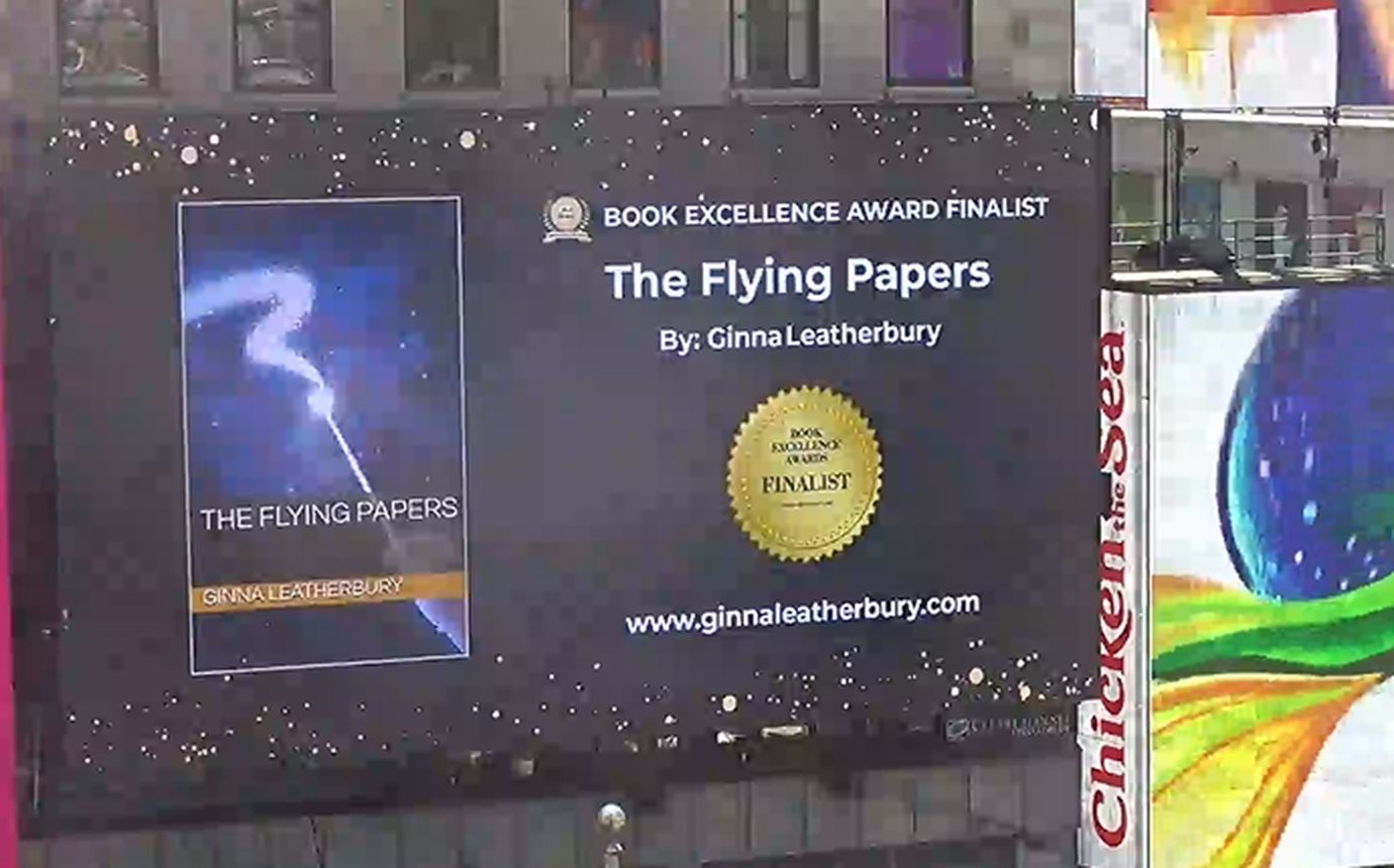 The Flying Papers on a billboard in New York City&rsquo;s Times Square, alongside Broadway advertisements